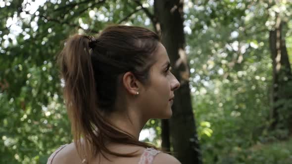 Following Caucasian female through the woods slow motion footage alt