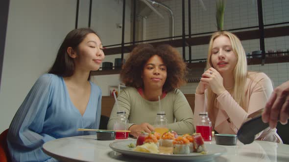 Black Woman Paying Bill Through Smartphone Using NFC Technology in Cafe alt
