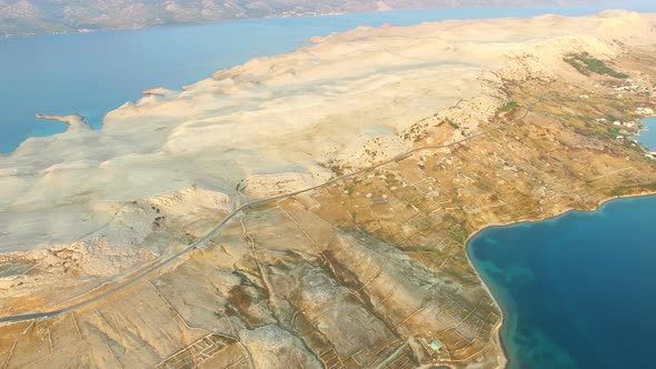 Aerial view of road through barren landscape of Pag island in Croatia alt