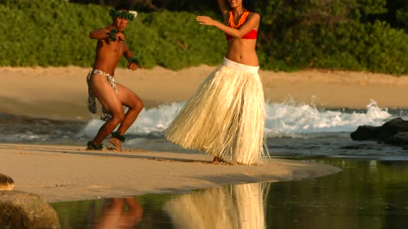 Polynesian dancers perform at beach in Hawaii, slow motion alt