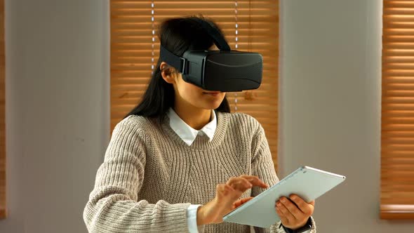 Female business executive using digital tablet with virtual glasses alt