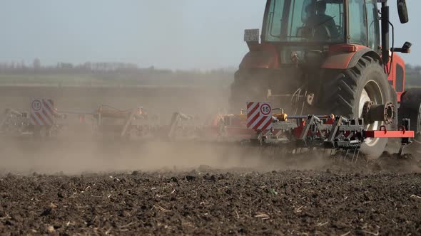 Agricultural Red Small Tractor in the Field Plowing Works in the Field alt