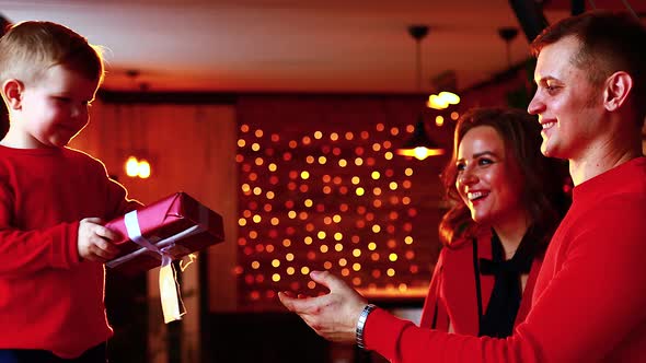 Portrait of Happy Young Family Together in Living Room alt