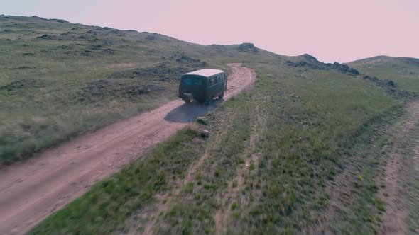 Aerial Footage Filmed with Drone of Pickup Car Riding in Steppe. the Car Travels Along the Steppe To alt