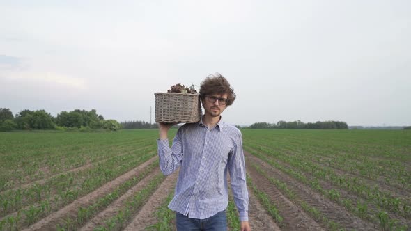 The Farmer is Holding a Box of Organic Vegetables
