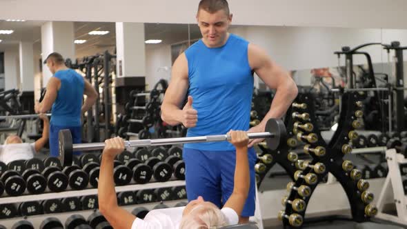 Elderly Woman Eldest is Engaged in Sports in Gym alt