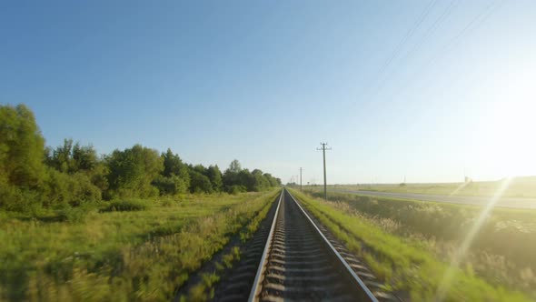 FPV Drone Flight Fast and Maneuverable Along Railway in a Clear Sunny Day alt