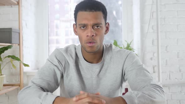 Portrait of AfroAmerican Man Gesturing Frustration and Anger Indoor alt