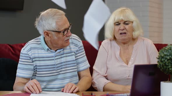 Stressed Senior Couple Discuss Unpaid Bank Debt Holding Bills, Doing Paperwork, Planning Budget alt