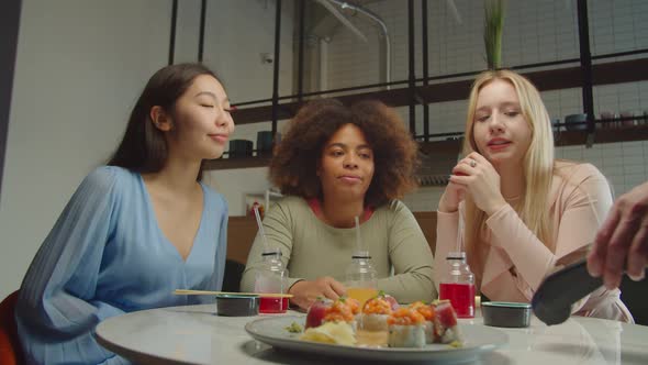 Black Woman Paying Bill Through Smartphone Using NFC Technology in Cafe alt