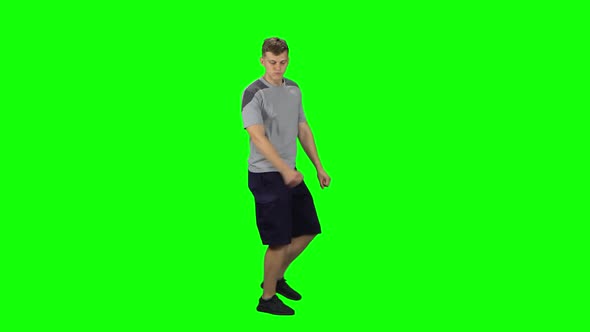 Guy Goes and Dances, Smiles and Rejoices on a Green screen.Profile Side View alt
