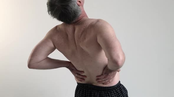 Man experiencing back pain alt