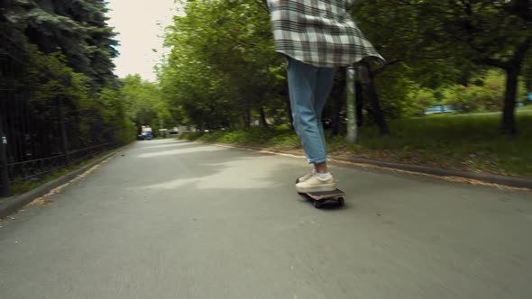 Teenage girl skateboarding in park alt