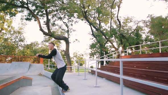 Young Man Doing Parkour Tricks in Extreme Sports Park alt