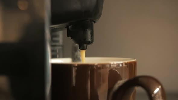 Coffee Pours Into a Cup of Coffee Machine