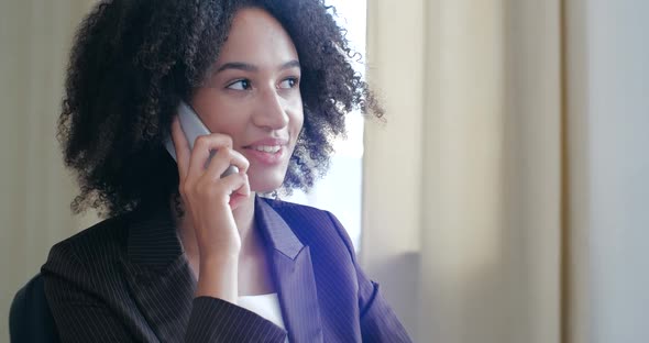Portrait Active African American Woman Speaks, Friendly Smile, Uses Mobile Phone To Communicate with alt