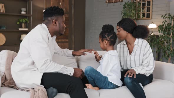 African American Parent Spending Time with Child Girl Daughter Sitting on Sofa at Home alt