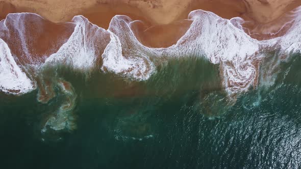 Sea coast, view from the height. Yellow sandy beach with blue sea. alt