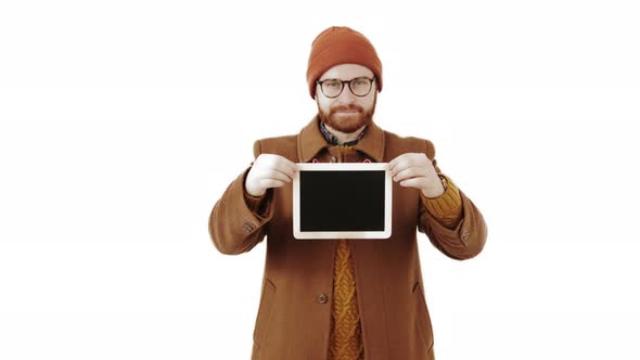 Attractive Man in Winter Coat Holding the Chalk Black Board with Copy Space alt