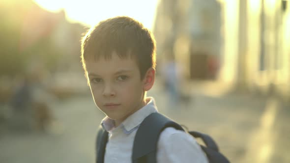 Portrait of a Schoolboy Looking at the Camera and Spinning