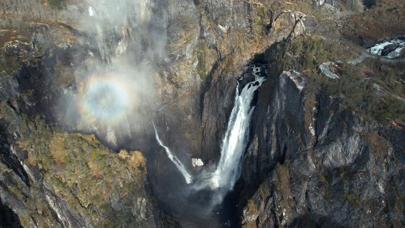 Aerial Overhead View Of Cascading Voringsfossen Waterfall In Norway With Rainbow Seen In Rising Mist alt