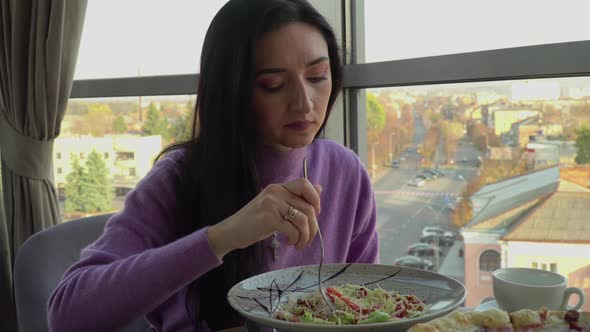 Girl Eats Salad In Cafe alt