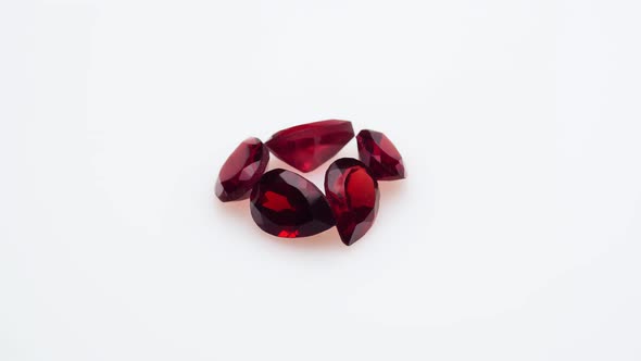Natural Red Garnet Gemstone on the White Background on the Turning Table alt