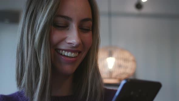 Beautiful Woman Laughing At Smartphone