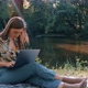 Girl working on a laptop in sunny weather - VideoHive Item for Sale