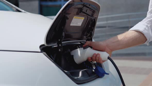 The Process of Connecting the Electric Car to the Charger alt