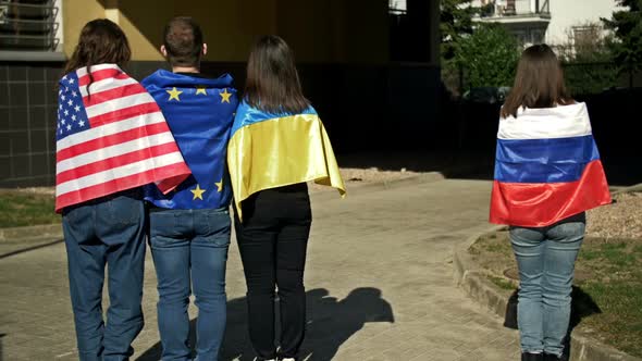 Group of Hugging People with the Flags of Ukraine the USA and the EU