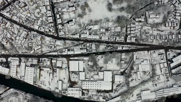 Straight down aerial footage in the winter time on a snowy day of the British town of Mirfield alt