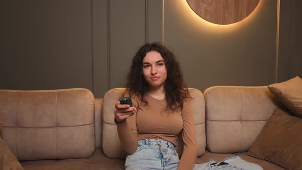 Woman Holding Tv Remote Control Changing Channel Searching Favorite Humor Show Sitting Cozy Couch alt