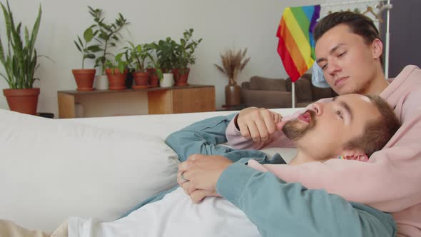 Two Lgbt Men are Lying on the Sofa Looking at Each Other and Talking alt