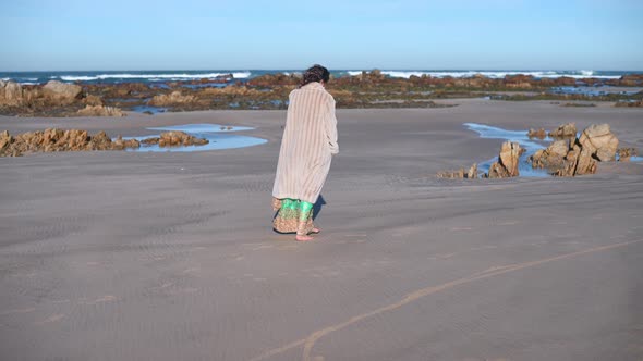 Woman Seen Walking Alone Along Coastline