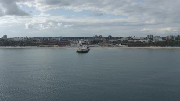 Low wide circling drone shot of Bournemouth Pier alt