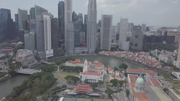 Aerial view of Singapore Marina Bay Sands mall with canal, road, cars. Modern skyscrapers in city. alt