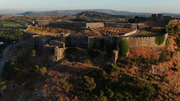 cinematic aerial shot at sunset and in orbit of Rozafa's Shkoder Castle. The river can be seen. Alba alt