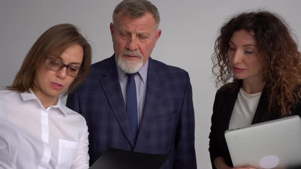 Three Successful Business People Working at Office