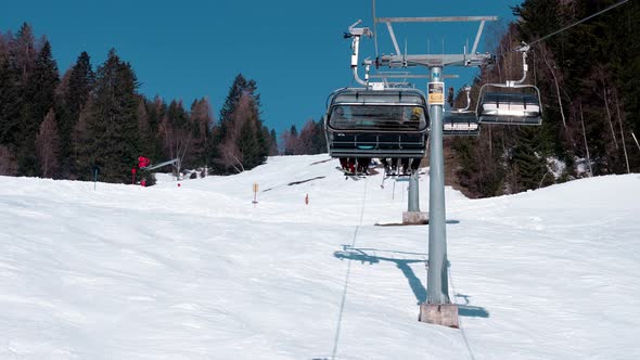 Ski Lift Moving Over Snowy Landscape in Austrian Alps alt