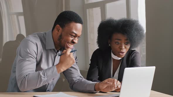 Happy American Business Man Focused Millennial Ethnic Woman Working on Laptop Computer in Office alt