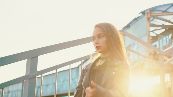 Rock Girl in Black Leather Jacket Walking Down Stairs on Golden Sunlight Background, Beautiful Girl alt