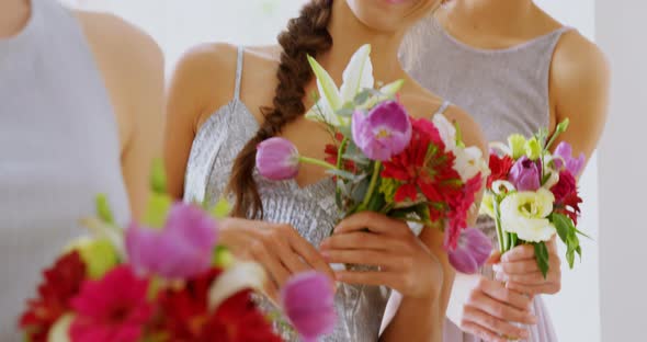 Happy bridesmaids in grey dresses holding flowers 4K 4k alt
