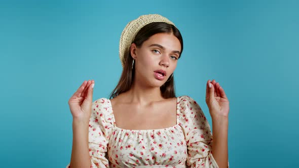 Cute Woman Showing Bla-bla-bla Gesture with Hands and Rolling Eyes Isolated on Blue Background alt