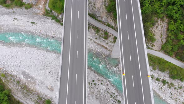 Aerial Top View of Viaduct with Multilane Highway and Tunnel. Traffic on Bridge in Mountains alt