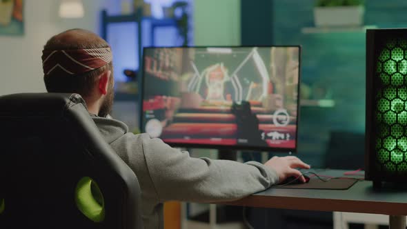 Professional Cyber Gamer Playing Shooter Videogame with New Graphics alt