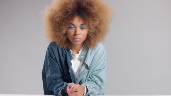 Mixed Race Black Woman with Big Afro Hair in Studio Alone Slow Motion Zoom Out alt