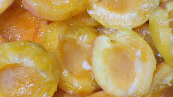 Juicy Apricot Slices on a Black Background Top View alt