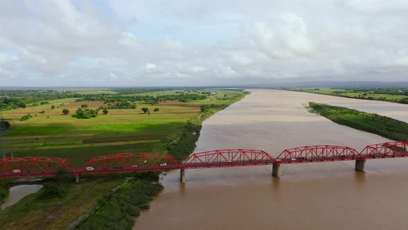 Cars Ride on the Bridge. Wide River on the Island of Luzon, Philippines, Aerial View alt
