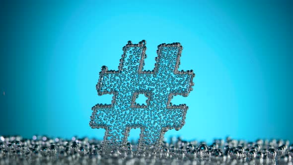 Hash Tag Sign Underwater in Bubbles of Oxygen on Blue Background alt